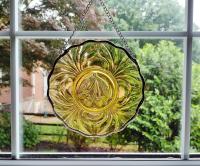 Six inch diameter vintage amber glass plate window hanging with a cherry motif. Comes with a chain and suction cup hanger.