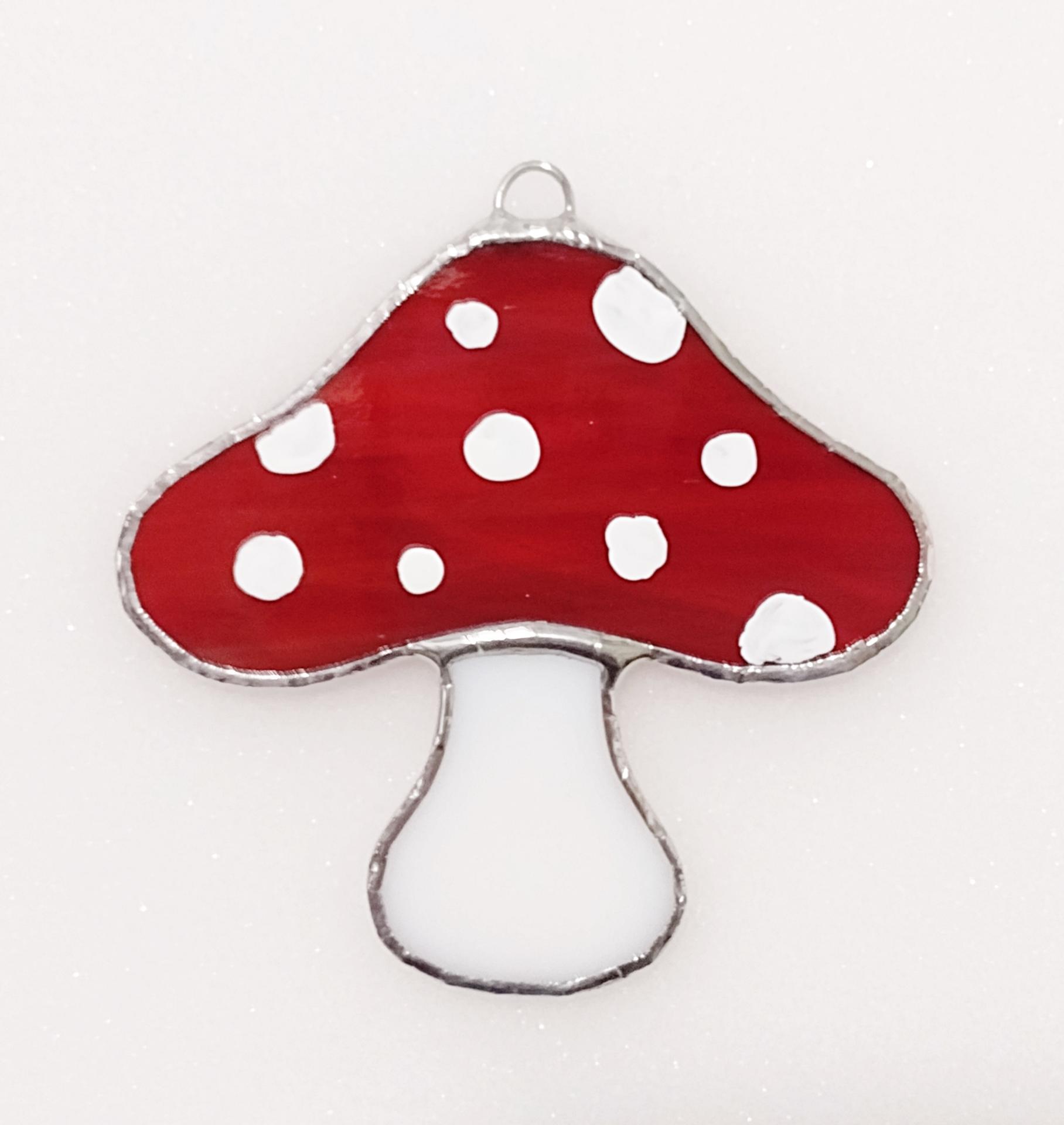 Red stained glass mushroom suncatcher with white spots and white stem.  Suction cup hanger included.