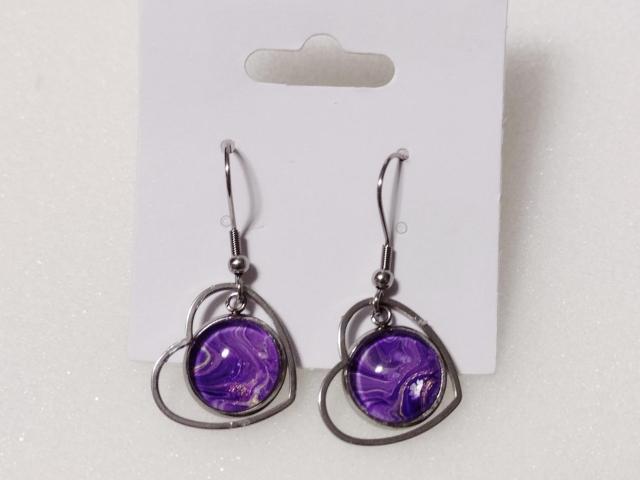 purple swirled paint dangle earrings with a wire heart surround.